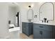 A bright bathroom boasts dual vanities with modern fixtures and a sleek design with ample natural light at 10010 Aspen Rose St # 102, Las Vegas, NV 89183