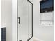 The bathroom showcases a contemporary glass-enclosed shower and neutral tile enhancing its modern aesthetic at 10010 Aspen Rose St # 102, Las Vegas, NV 89183