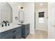 A bathroom features dual vanities, modern lighting, and a glass-enclosed shower with an open, airy feel at 10010 Aspen Rose St # 102, Las Vegas, NV 89183