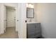 Modern bathroom with gray vanity, mirror, and great lighting at 10010 Aspen Rose St # 102, Las Vegas, NV 89183