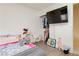 Cozy bedroom with wood floors, flat screen TV, and closet storage at 10010 Aspen Rose St # 102, Las Vegas, NV 89183