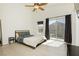 This bedroom boasts a spacious layout with bright natural light and access to a private balcony at 10010 Aspen Rose St # 102, Las Vegas, NV 89183