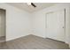 Minimalist bedroom with sliding closet doors and laminate flooring offers a clean and functional space at 10010 Aspen Rose St # 102, Las Vegas, NV 89183