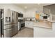 This bright kitchen features stainless steel appliances and white cabinets at 10010 Aspen Rose St # 102, Las Vegas, NV 89183
