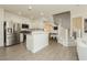 Bright open floor plan kitchen with stainless steel refrigerator and white cabinetry at 10010 Aspen Rose St # 102, Las Vegas, NV 89183