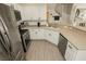 The kitchen is fully stocked with stainless steel appliances and white cabinets at 10010 Aspen Rose St # 102, Las Vegas, NV 89183