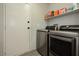 A laundry room featuring new washer and dryer units and shelving for storage at 10010 Aspen Rose St # 102, Las Vegas, NV 89183