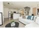 Bright living room showcases an open floor plan with sleek floors, modern decor, and a stylish staircase at 10010 Aspen Rose St # 102, Las Vegas, NV 89183