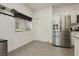 Adjacent to the kitchen is a pantry and a stainless steel refrigerator at 10010 Aspen Rose St # 102, Las Vegas, NV 89183