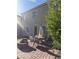 Back patio with brick pavers, an outdoor table with seating, and a fire pit at 109 Delighted Ave, North Las Vegas, NV 89031