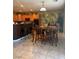 Dining area with wood table and chairs, tile flooring, and bar seating at 109 Delighted Ave, North Las Vegas, NV 89031