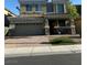 Two-story home featuring a two-car garage, covered entryway, and well-maintained landscaping at 109 Delighted Ave, North Las Vegas, NV 89031