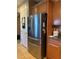 Kitchen features a stainless steel refrigerator and dark wood cabinets with granite countertops at 109 Delighted Ave, North Las Vegas, NV 89031