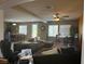 Spacious living room with ceiling fan, neutral paint, and windows overlooking the back yard at 109 Delighted Ave, North Las Vegas, NV 89031