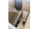 Bright staircase with white banister, carpeted steps, and tile entryway at 109 Delighted Ave, North Las Vegas, NV 89031