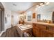 Spacious bathroom featuring a large soaking tub, dual vanities, separate shower and wood-look floors at 11285 Fiesole St, Las Vegas, NV 89141