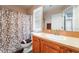 Bathroom features a tub with shower, vanity, wood cabinet, neutral wall, and a toilet at 11285 Fiesole St, Las Vegas, NV 89141