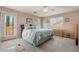 This main bedroom has a ceiling fan, carpet, natural light, and a door to a small balcony at 11285 Fiesole St, Las Vegas, NV 89141