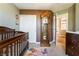 Stylish Bedroom room with neutral walls, crib, grandfather clock and closet at 11285 Fiesole St, Las Vegas, NV 89141