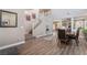 Open-concept dining room with hardwood floors and a staircase leading to the upper level at 11285 Fiesole St, Las Vegas, NV 89141