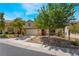 Charming two-story home with desert landscaping, stone accents, mature trees, and a two-car garage at 11285 Fiesole St, Las Vegas, NV 89141