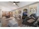 Open-concept living room featuring a fireplace, dining area, and modern massage chair for ultimate relaxation at 11285 Fiesole St, Las Vegas, NV 89141