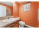 Cozy powder room featuring a decorative vanity, a toilet, and a window for natural lighting at 11285 Fiesole St, Las Vegas, NV 89141