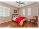 Cozy bedroom with hardwood floors and a ceiling fan, featuring plenty of natural light at 11405 Perugino Dr, Las Vegas, NV 89138