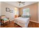 Cozy bedroom featuring hardwood floors, a comfortable bed, and natural light from the window at 11405 Perugino Dr, Las Vegas, NV 89138