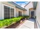Close-up of the home's entrance, showcasing well-maintained landscaping and a secure screen door at 11405 Perugino Dr, Las Vegas, NV 89138