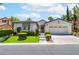 Attractive single-story home featuring a gated entrance, landscaped yard, and a two-car garage at 11405 Perugino Dr, Las Vegas, NV 89138