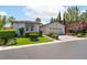 Inviting single-story home with lush landscaping, a two-car garage, and well-maintained lawn at 11405 Perugino Dr, Las Vegas, NV 89138