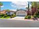 Charming single-story home featuring a two-car garage and beautifully landscaped front yard at 11405 Perugino Dr, Las Vegas, NV 89138