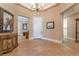 Elegant foyer features neutral tones, decorative chandelier, tile flooring and furniture at 11405 Perugino Dr, Las Vegas, NV 89138