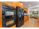Bright kitchen features black appliances, wooden cabinetry and tile backsplash at 11405 Perugino Dr, Las Vegas, NV 89138