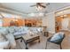 Open-concept living room with tile flooring, neutral tones, and lots of natural light at 11405 Perugino Dr, Las Vegas, NV 89138