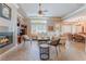 Open-concept living room with fireplace, coffered ceiling, shutters and view of dining area at 11405 Perugino Dr, Las Vegas, NV 89138