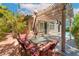 Cozy outdoor dining area with a pergola, patio furniture, and a view of the backyard at 11405 Perugino Dr, Las Vegas, NV 89138