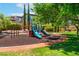 Community playground with slides and play equipment in a well-maintained grassy area at 11405 Perugino Dr, Las Vegas, NV 89138