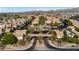 Beautiful Primary-planned community featuring well-manicured lawns, pool, and lush green landscaping at 1185 Via Dimartini, Henderson, NV 89052