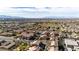 Beautiful aerial view showcasing a well-maintained neighborhood with mature trees and mountain backdrop on a sunny day at 1185 Via Dimartini, Henderson, NV 89052