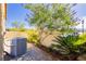 Outdoor backyard featuring landscaping, an air conditioning unit, and concrete pavers at 1185 Via Dimartini, Henderson, NV 89052