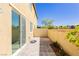 View of backyard with concrete pavers, a block wall, a home, and a sliding glass door at 1185 Via Dimartini, Henderson, NV 89052