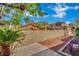 This backyard features a brick patio, partial rock ground cover, and block fence at 1185 Via Dimartini, Henderson, NV 89052
