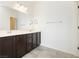 Bathroom featuring dual sinks, large mirror, and modern finishes, adding convenience and style at 1185 Via Dimartini, Henderson, NV 89052