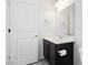Cozy bathroom showcases dark vanity cabinet, white countertop, toilet, and a modern round mirror at 1185 Via Dimartini, Henderson, NV 89052