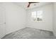 Bedroom with neutral paint, a ceiling fan, large window with white blinds, and gray carpet at 1185 Via Dimartini, Henderson, NV 89052