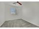 This carpeted bedroom features a modern ceiling fan and bright window at 1185 Via Dimartini, Henderson, NV 89052