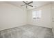 Inviting bedroom featuring a ceiling fan, plush carpet, and natural light at 1185 Via Dimartini, Henderson, NV 89052