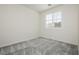 Well-lit bedroom showcasing a window with shutter, offering a cozy atmosphere at 1185 Via Dimartini, Henderson, NV 89052